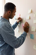 © Demetr White/Stocksy - man writing on a sticker