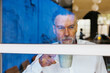 © BONNINSTUDIO/Stocksy - Senior man with cup of coffee in office