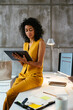 © BONNINSTUDIO/Stocksy - Concentrated businesswoman using tablet