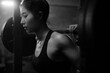 © Albert Law - Young Asian female training in gym with weights at night