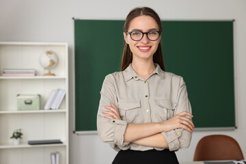 Wall Mural - Portrait of beautiful young teacher in classroom