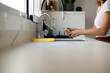 © Guille Faingold/Stocksy - Woman doing washing-up in kitchen.