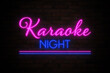 © New Africa - Glowing neon sign with words Karaoke Night on brick wall