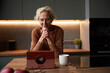 © Elenka Kharichka/Stocksy - Woman using digital tablet relaxed at home.