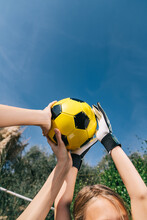 Humans Hands Holding A Soccer Ball