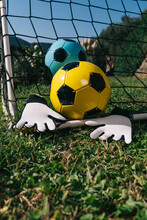 Two Soccer Balls And Goalkeeper's Gloves