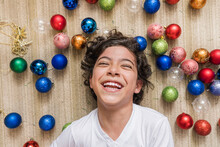 Laughing Child Playing With Christmas Balls. 
