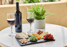 Bottle Of Wine And Glasses With Cheese Plate