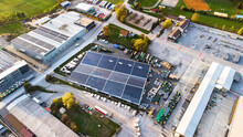 Industrial Warehouse With Solar Panels In The Countryside Aerial View