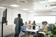 © Pedro Merino/Stocksy - Group of multiracial office workers in a meeting