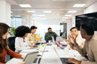 © Pedro Merino/Stocksy - Coworkers during a brainstorming meeting in the office