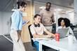 © Pedro Merino/Stocksy - Group of office colleagues working cooperatively in a coworking