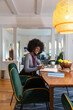 © Raymond Forbes LLC/Stocksy - Confident African American Woman at home with laptop computer