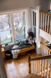 © Raymond Forbes LLC/Stocksy - Black Girl at home relaxing listens to music on bluetooth speaker