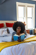 © Raymond Forbes LLC/Stocksy - Black Lifestyle Girl relaxing at home reading book