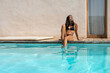 © Bisual Studio/Stocksy - Woman Relaxed At The Pool
