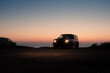 © Ibai Acevedo/Stocksy - 4x4 jeep with headlights on at cliff during sunset