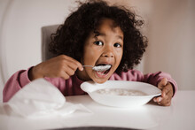 Toddler Eating Rice Pudding