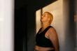 © Tania Cervian/Stocksy - Model standing in sun shining through window