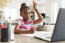 African American Girl Sitting At Table, Using Laptop For Online Lesson