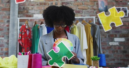 Wall Mural - Animation of puzzle pieces over african american female designer