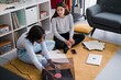 © Studio Marmellata/Stocksy - Happy diverse ladies choosing vinyl records on floor