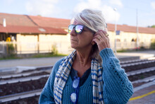 Senior Woman At Train Station Portrait