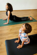 © Valentina Barreto/Stocksy - Mother and son doing yoga together in studio