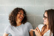 © Valentina Barreto/Stocksy - Two women laughing looking each other portrait
