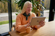 © Elenka Kharichka/Stocksy - Albino blogger with a tablet streams from a cafe