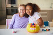 © Dmitry Borovikov/Stocksy - Child girls are photographed with a pumpkin for the Halloween holiday
