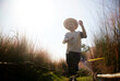 © ChaoShu Li/Stocksy - Cute little Asian boy in Muhlenbergia capillaris area outdoors