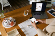 © ByLorena/Stocksy - Woman taking photo of product at desk