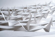 © Catherine MacBride/Stocksy - Triangular shapes cut from plain paper resembling bird wings