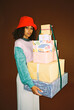 © BONNINSTUDIO/Stocksy - User-generated content serious female with stack of wrapped gifts