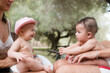 © Ibai Acevedo/Stocksy - Happy baby brothers having fun together