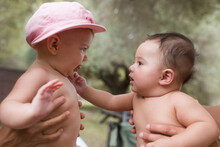 Portrait Of Two Babies Playing Together