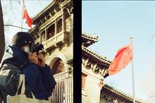 People Taking Photos Standing Under The Red Flag