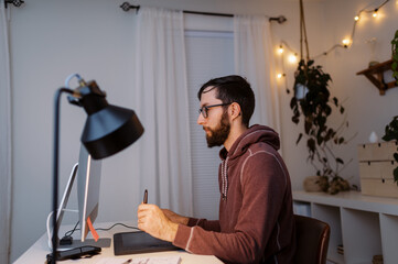 Creative entrepreneur working late at night in home office
