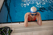 Woman Breathing Hard At The Swimming Pools Edge.