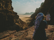 Friends Walking Towards A Viewpoint In Wadi Rum