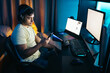 © Pedro Merino/Stocksy - Gamer using smartphone while playing video games on PC