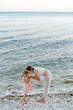 © Sergey Narevskih/Stocksy - Mother with daughter on beach