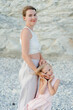 © Sergey Narevskih/Stocksy - Portrait of woman with child on rocky beach
