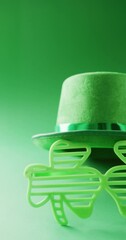 Sticker - Vertical video of of st patrick's green hat and shamrock glasses with copy space on green background