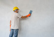 © Verin - a man holding trowel plaster cement wall, concept of plaster work,home building, house renovation