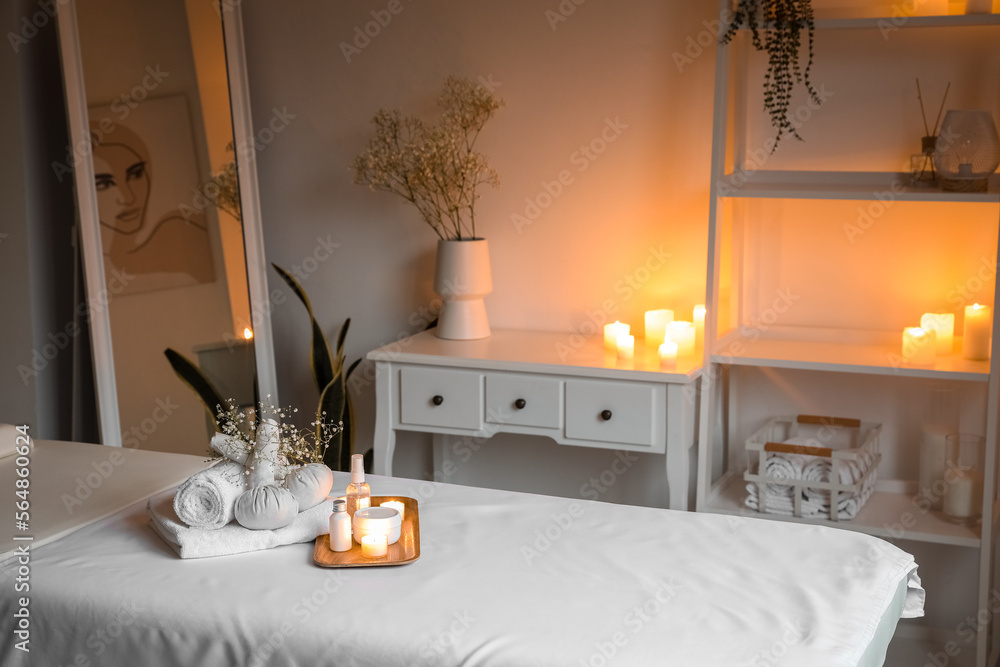 Spa composition with gypsophila flowers on couch in salon
