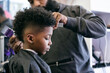 © Sean Locke/Stocksy - Barber: Side View Of Boy Sitting For Haircut