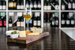 © Sean Locke/Stocksy - Sampling Of Cheeses On A Board With White Wine