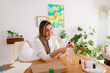 © ByLorena/Stocksy - Natural cosmetic entrepreneur woman mixing oils at desk